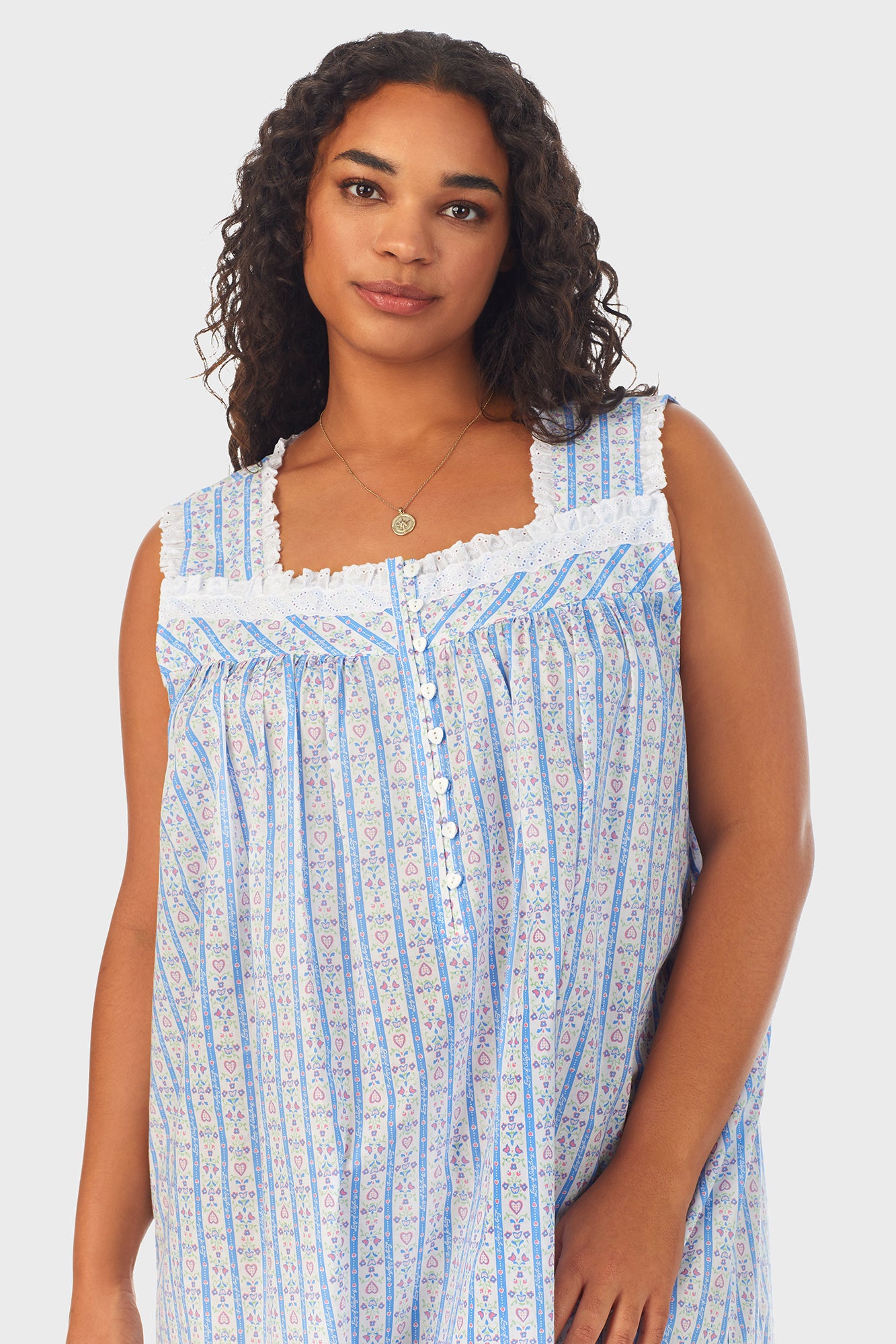 A lady wearing white long nightgown with blue pattern