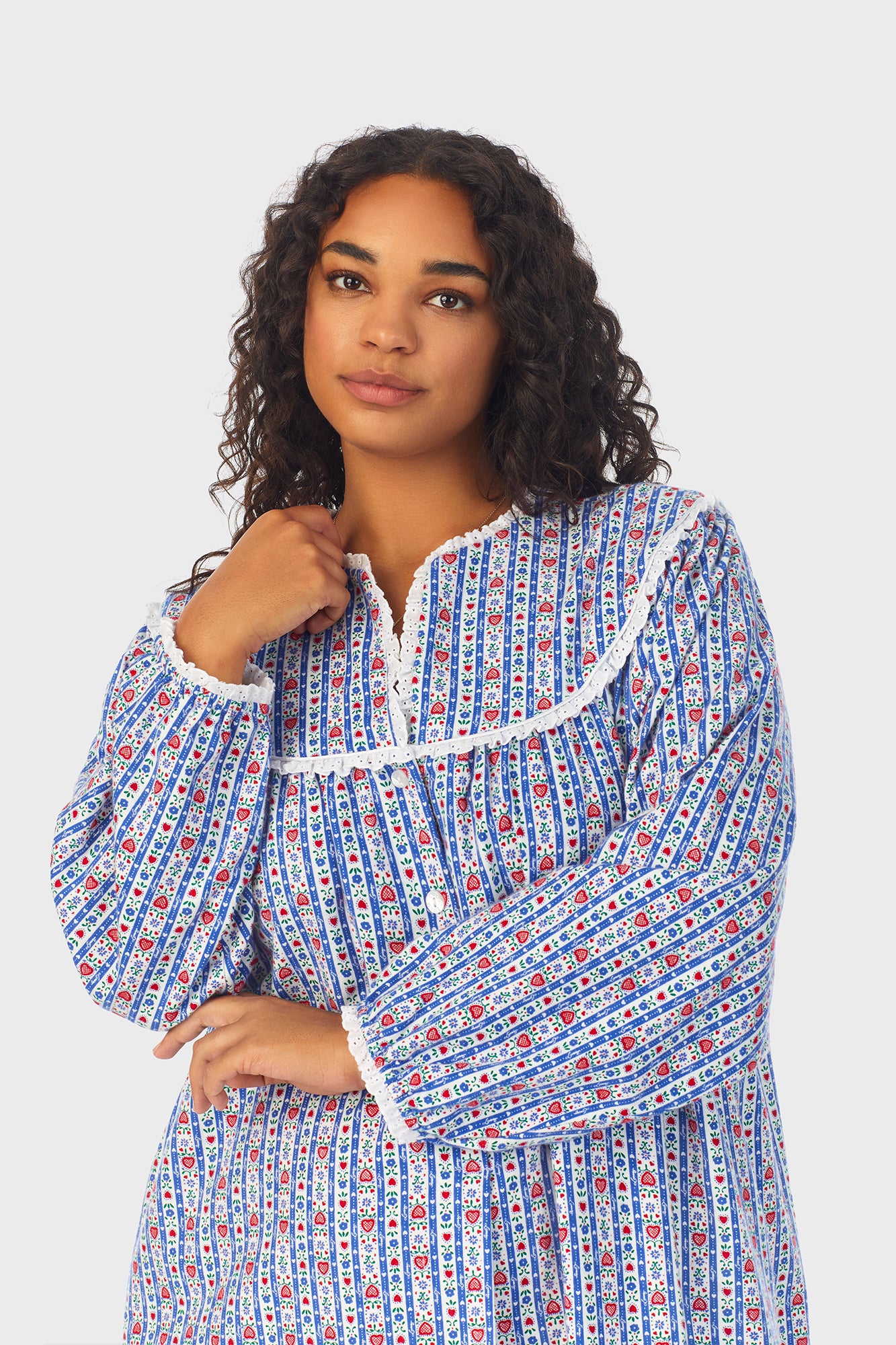  A lady wearing a blue long sleeve flannel nightgown plus with tyrolean stripe pattern.