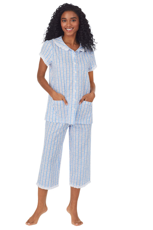 A lady wearing white pajama with blue pattern