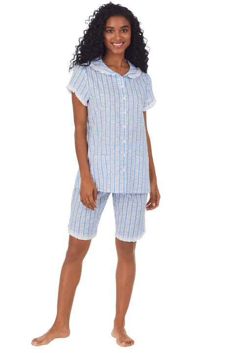 A lady wearing white short pajama set with blue pattern