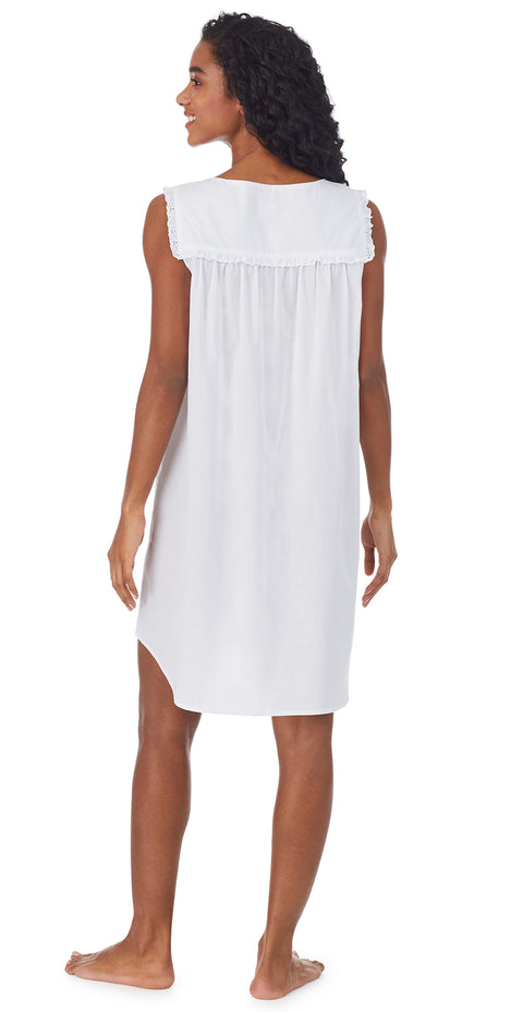 A lady wearing a white cotton chemise.