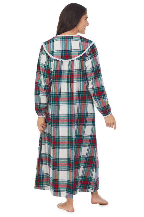 A lady wearing a holiday plaid long sleeve flannel gown.