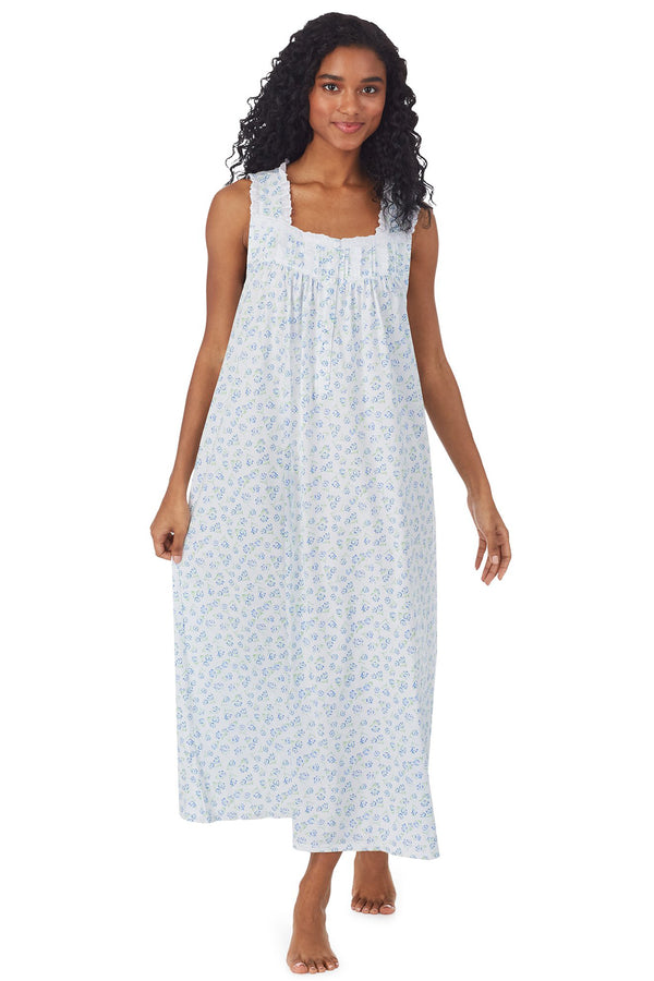 A lady wearing white long nightgown with blue floral design
