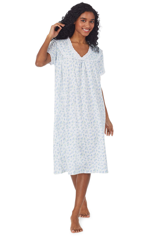 A lady wearing white waltz nightgown with blue floral design