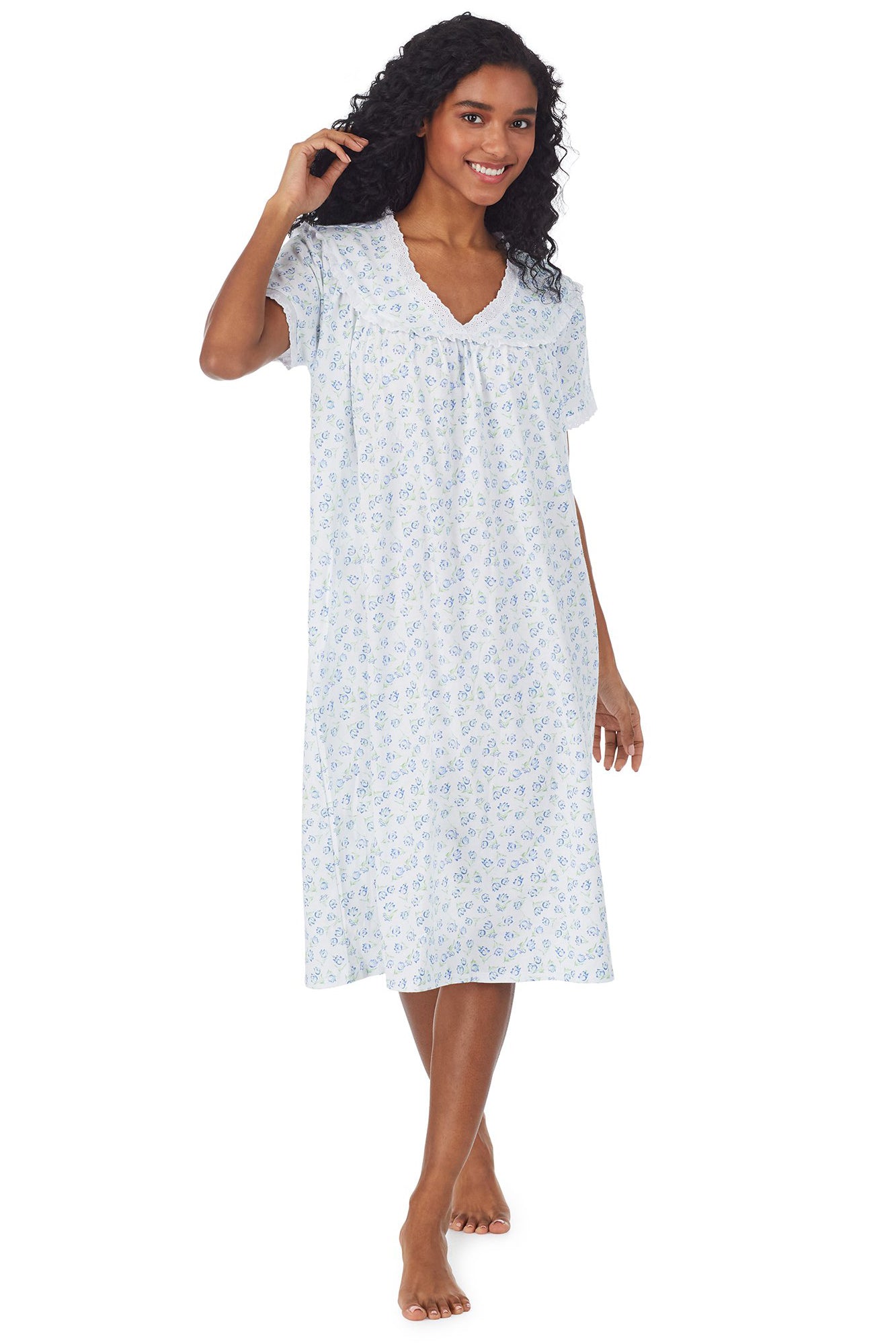 A lady wearing a white short sleeve knit waltz nightgown with tulip pattern.