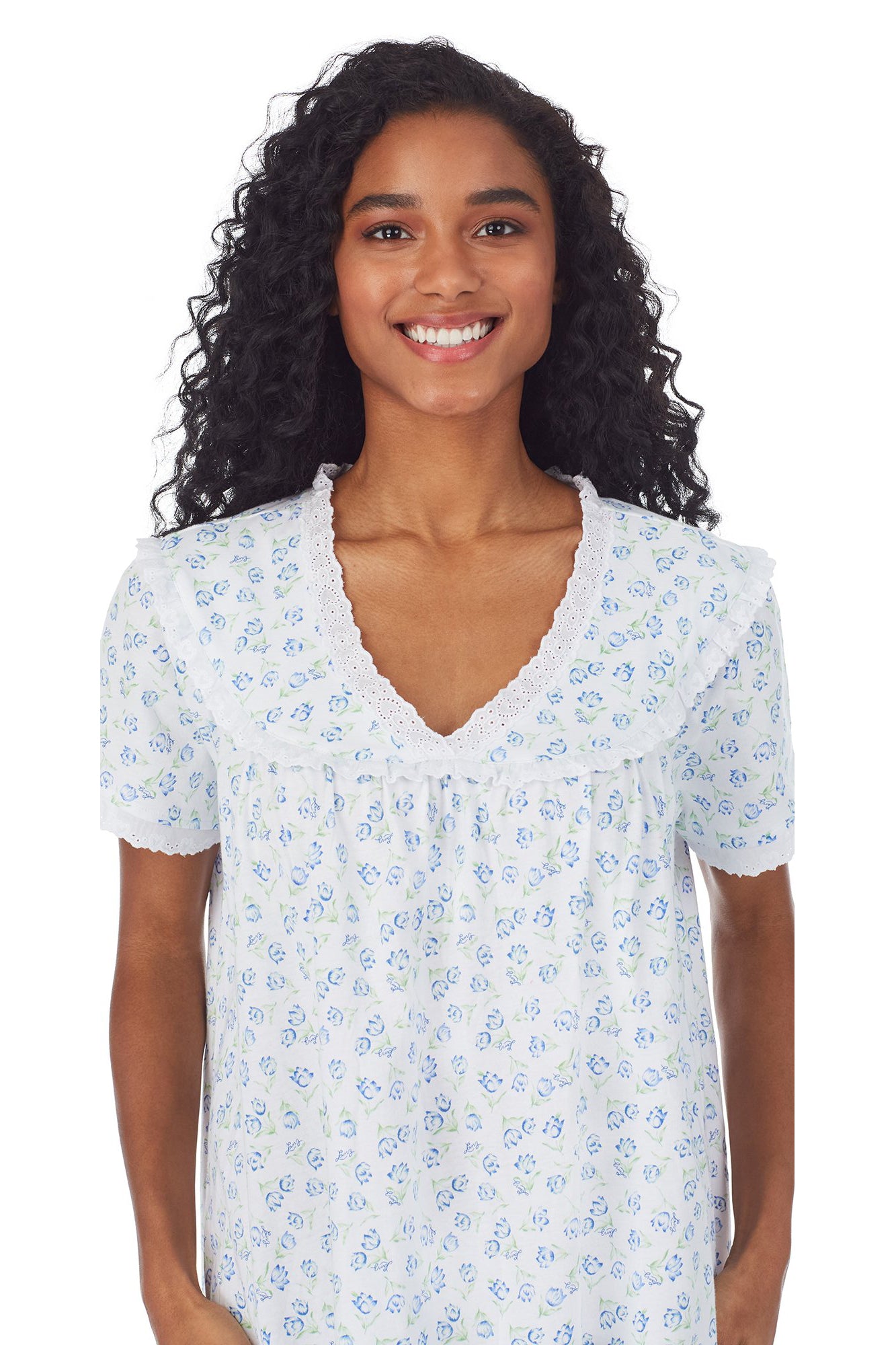 A lady wearing a white short sleeve knit waltz nightgown with tulip pattern.
