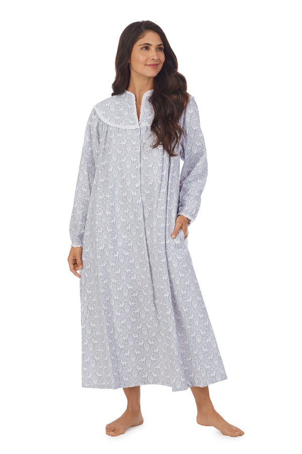 A lady wearing a grey long sleeve flannel gown with floral pattern.